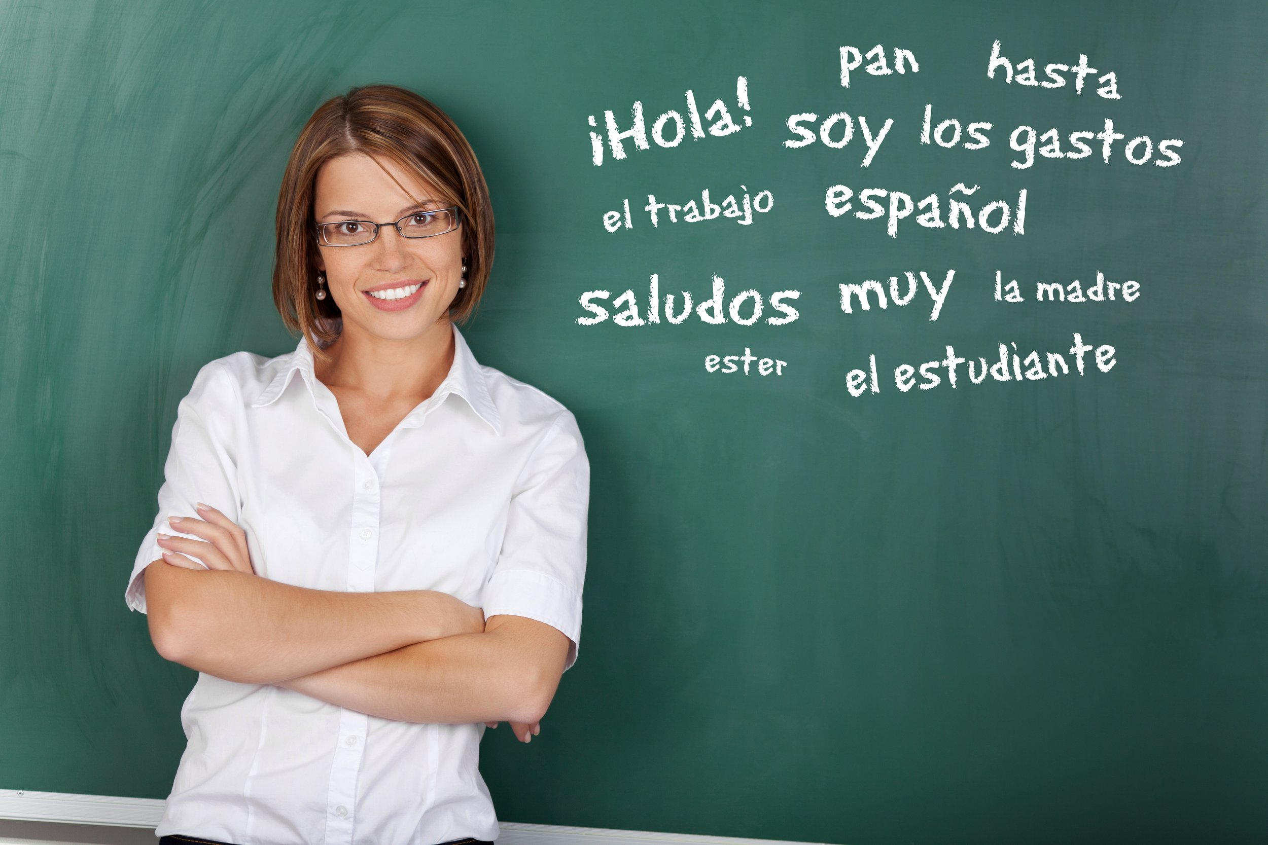 Spanish teacher standing in front of a chalkboard