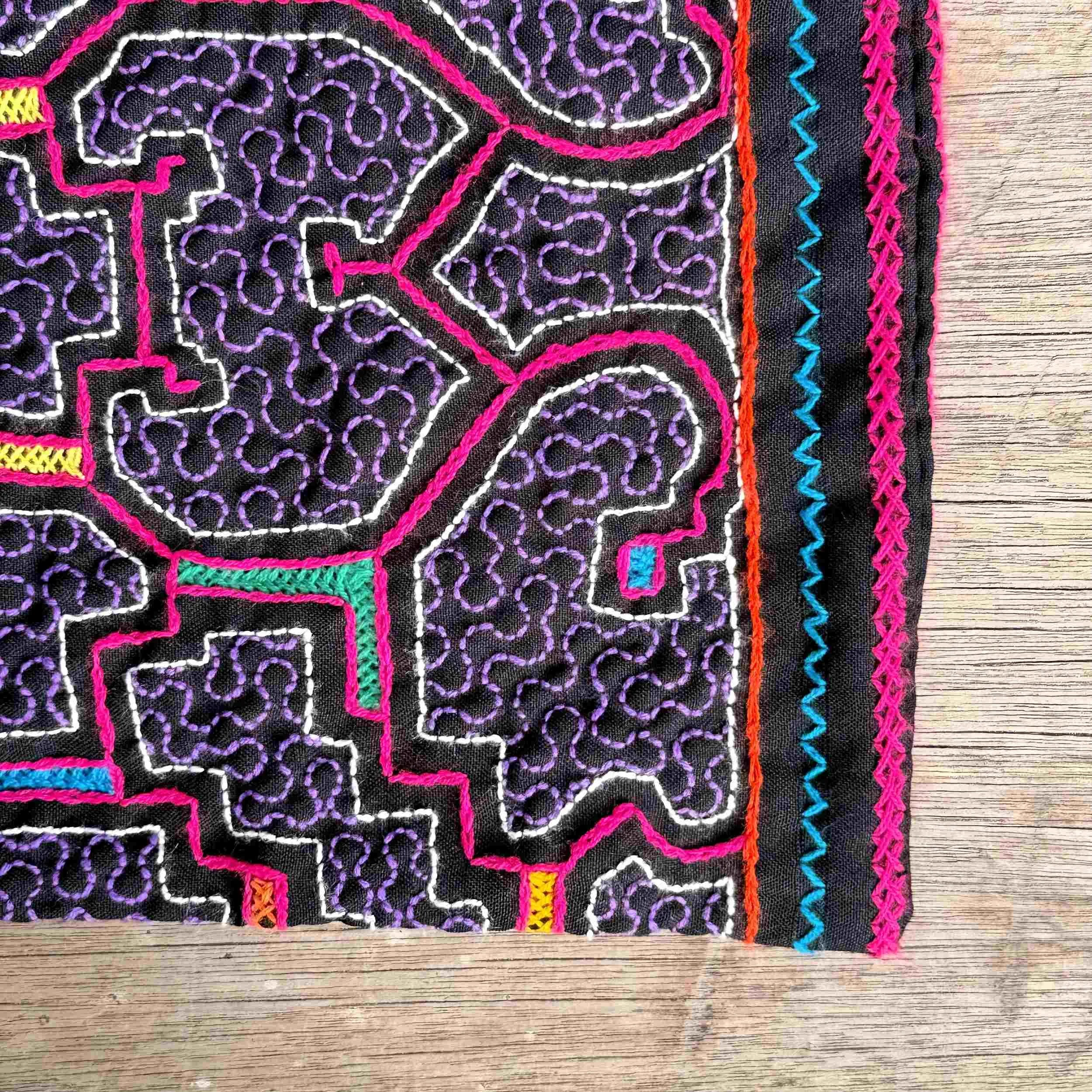 nine-handmade-peruvian-embroidered-bag-black-pink-pattern-detail.jpg