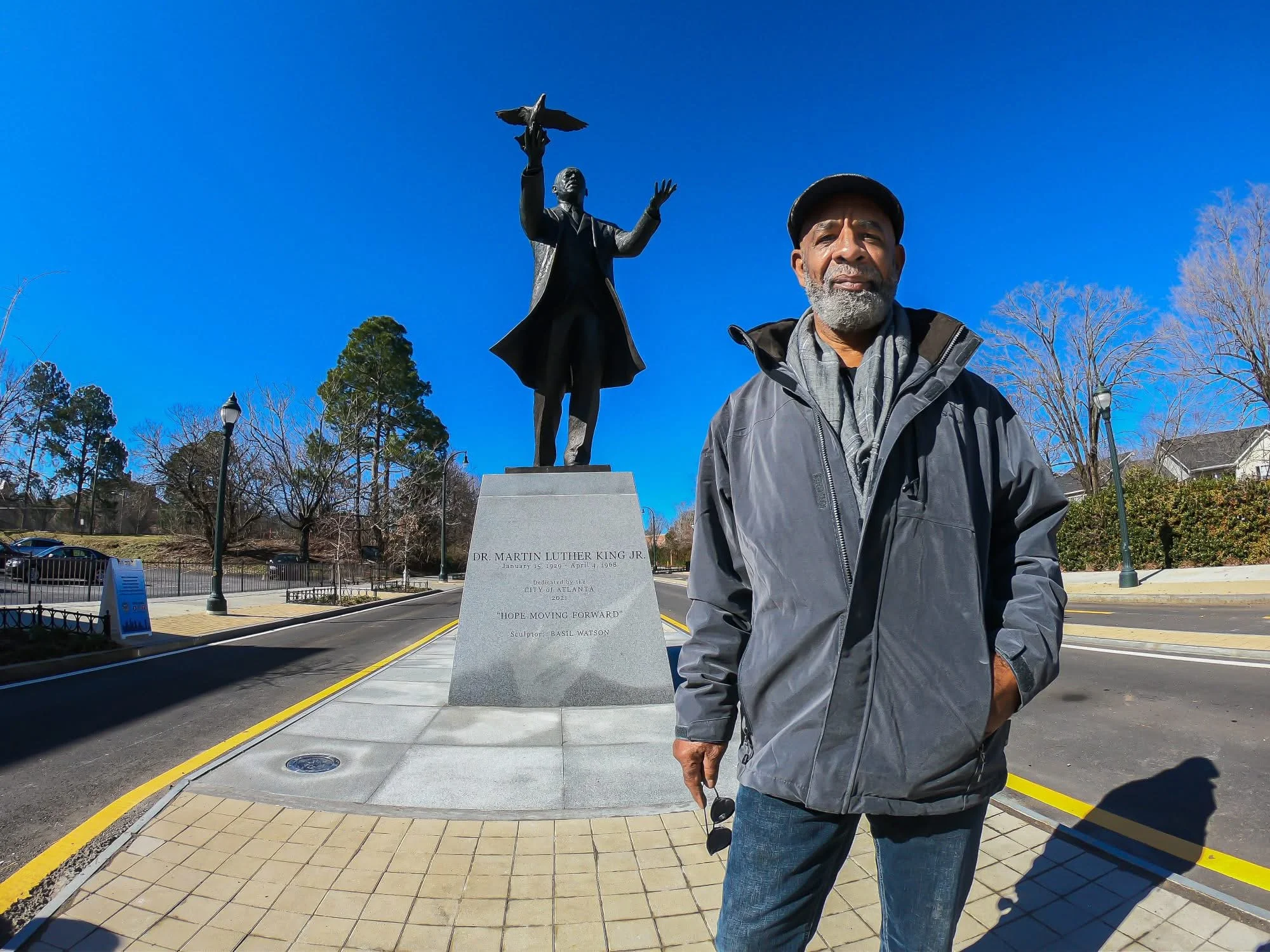 Sculptor Basil Watson stands in front of his bronze statue of Dr. Martin Luther King, Jr. after its official unveiling 011421 in Atlanta, Georgia