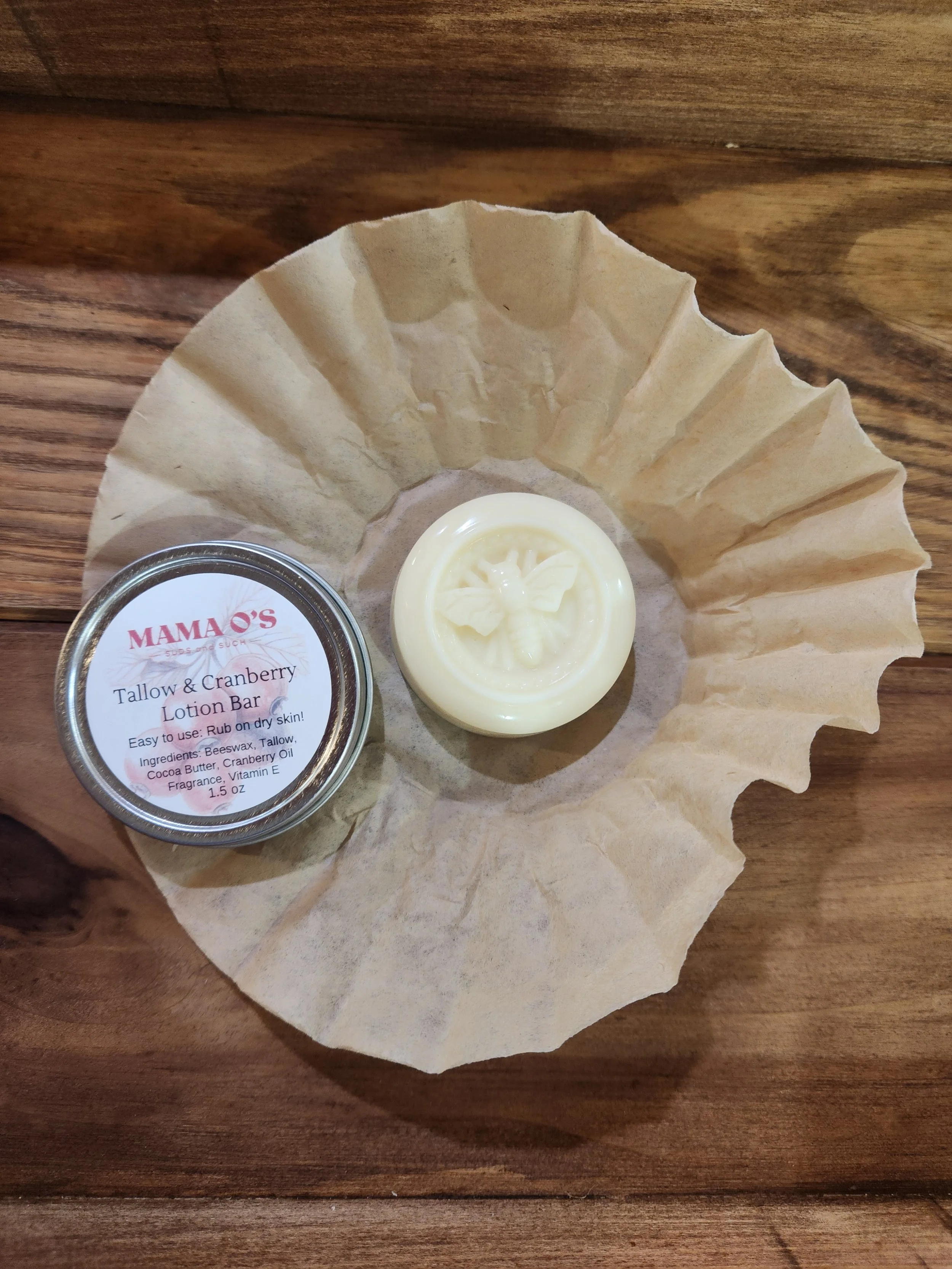 image of a solid lotion bar with an imbossed bee and the unbleached coffee filter used to wrap the lotion bar with a aluminium tin for packaging.