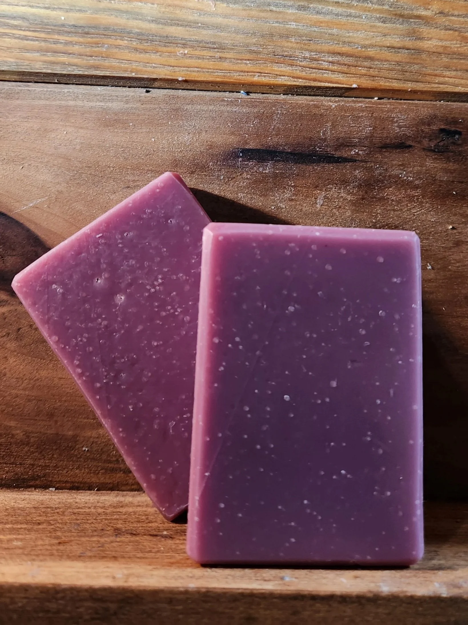 purple soap bars with a wood grain background.
