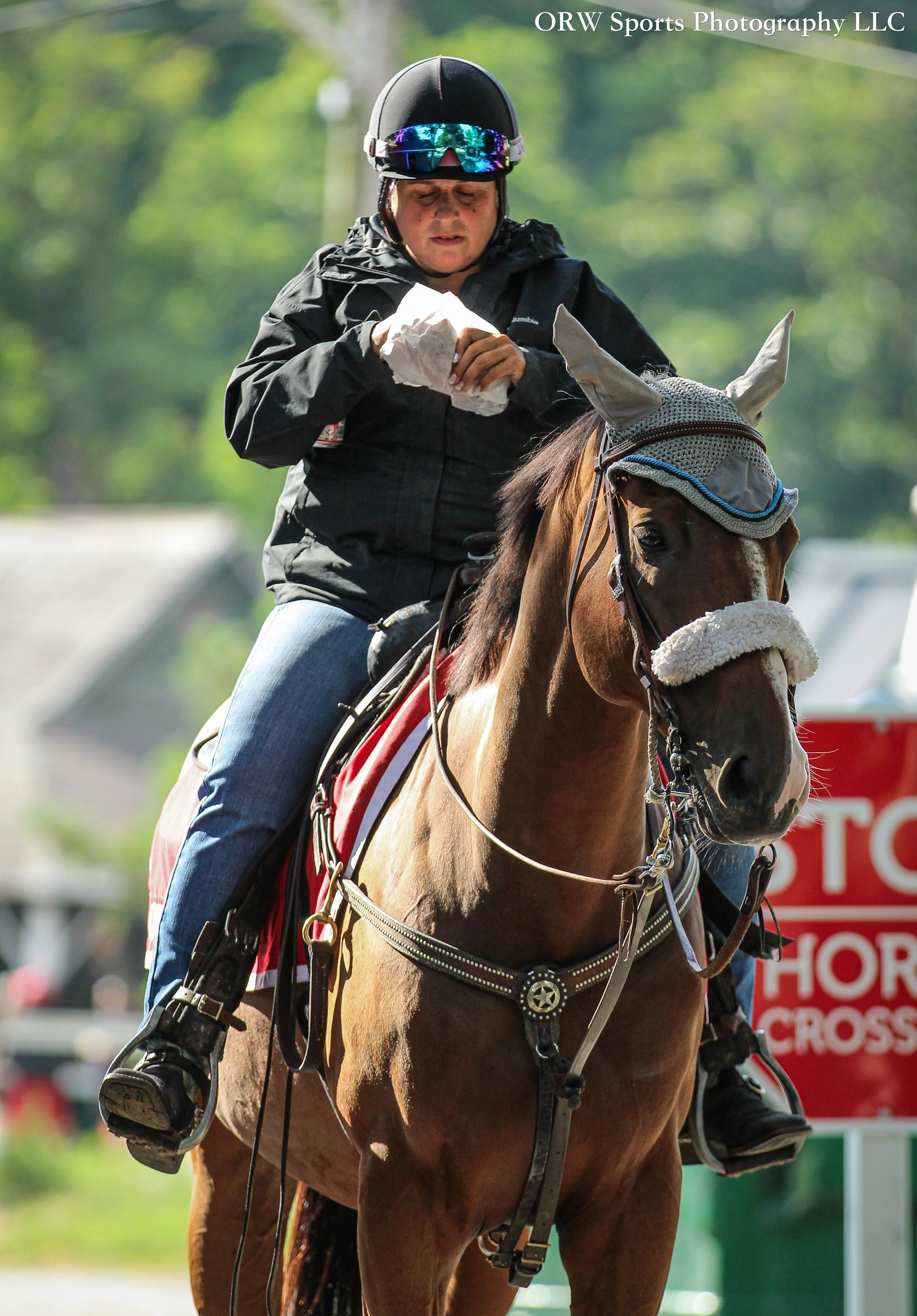 Natalie, one of the many skilled outriders at Saratoga, has breakfast aboard her horse by the Morning Line Cafe