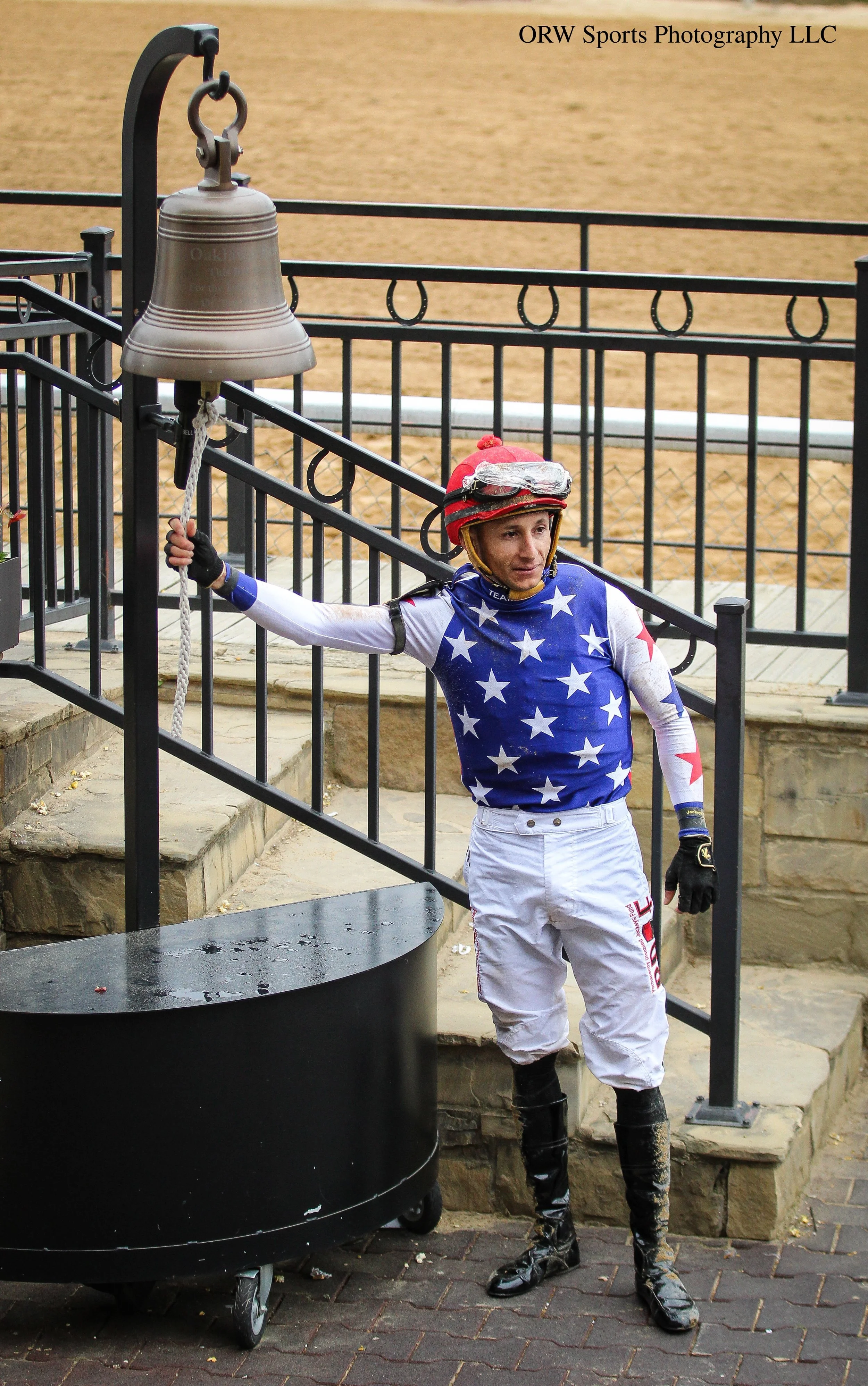 Francisco Arrieta rings the winner's circle bell. Each time this bell is rung, $1,000 is raised for Thoroughbred aftercare in the state of Arkansas. 
