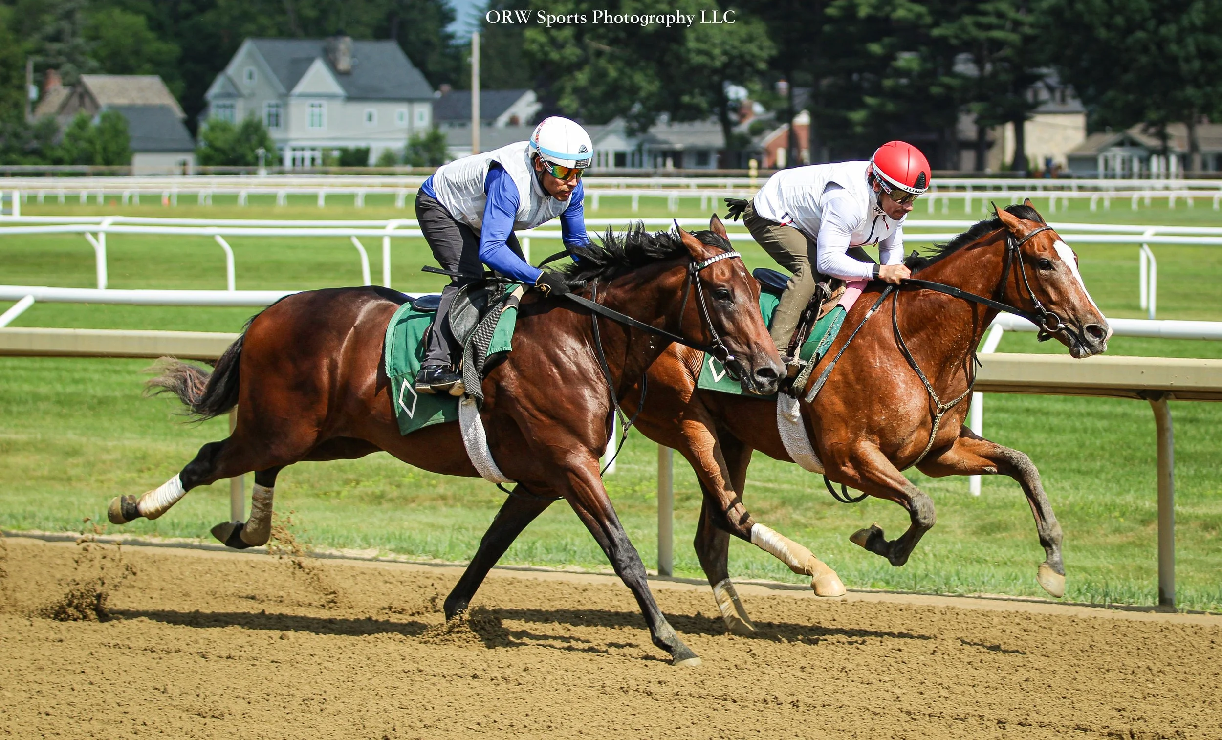 Jimmy Quispe (blue) and Junior Alvarado (red) breeze a duo for Bill Mott
