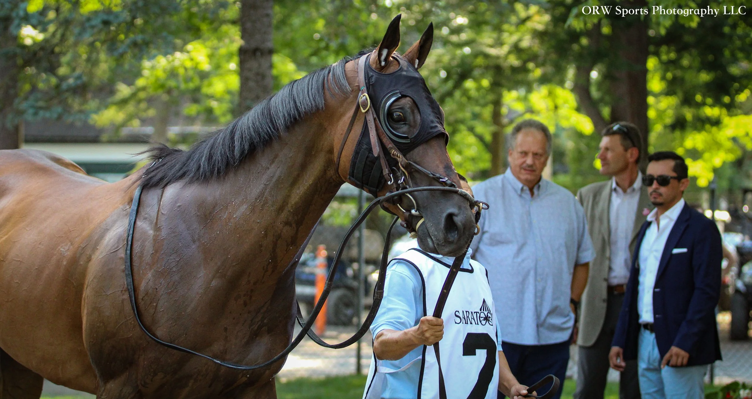 Twenty Six Black. Trainer Horacio De Paz is in the background donning sunglasses and a dark jacket 
