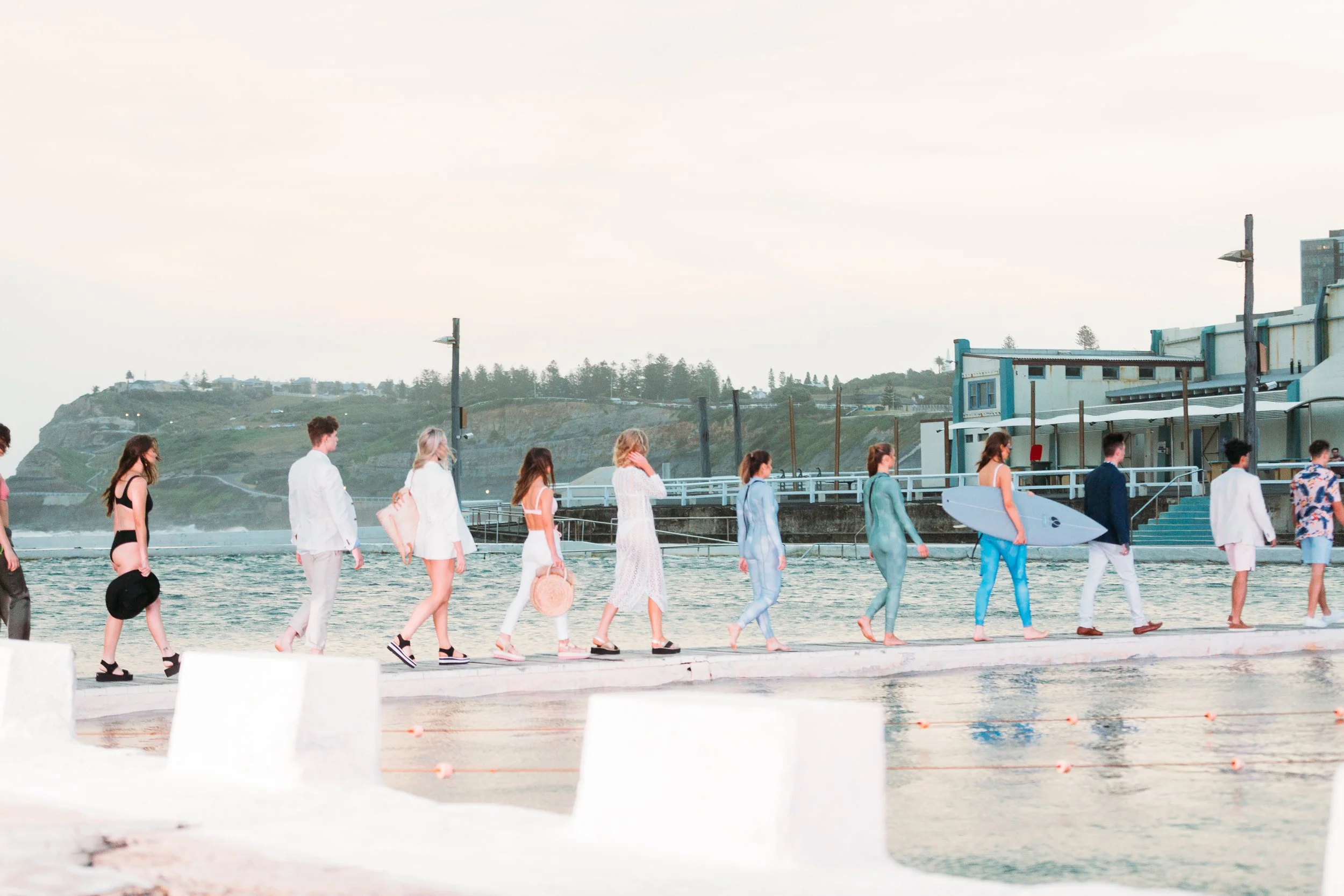 Models Walking along an outdoor runway at ocean baths, for a summer runway to launch a summer fashion magazine in Australia.