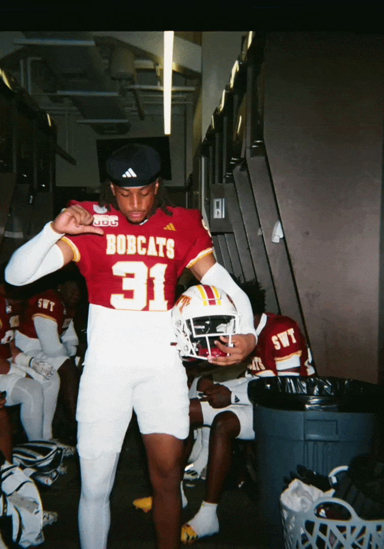 A young football player in a red and white uniform with the number 31 and