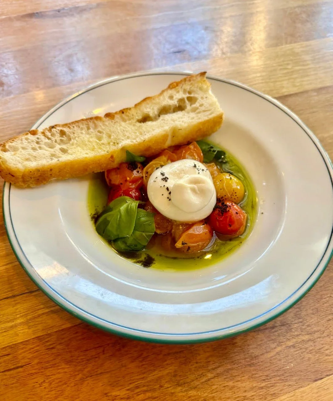 Dining with us this weekend? Start off your feast with our creamy, dreamy burrata!⁠
⁠
Paired with a cherry confit medley of tomatoes, drizzled in basil olive oil and served with warm garlic focaccia, it tastes as beautiful as it looks.⁠
⁠
Fresh, brig
