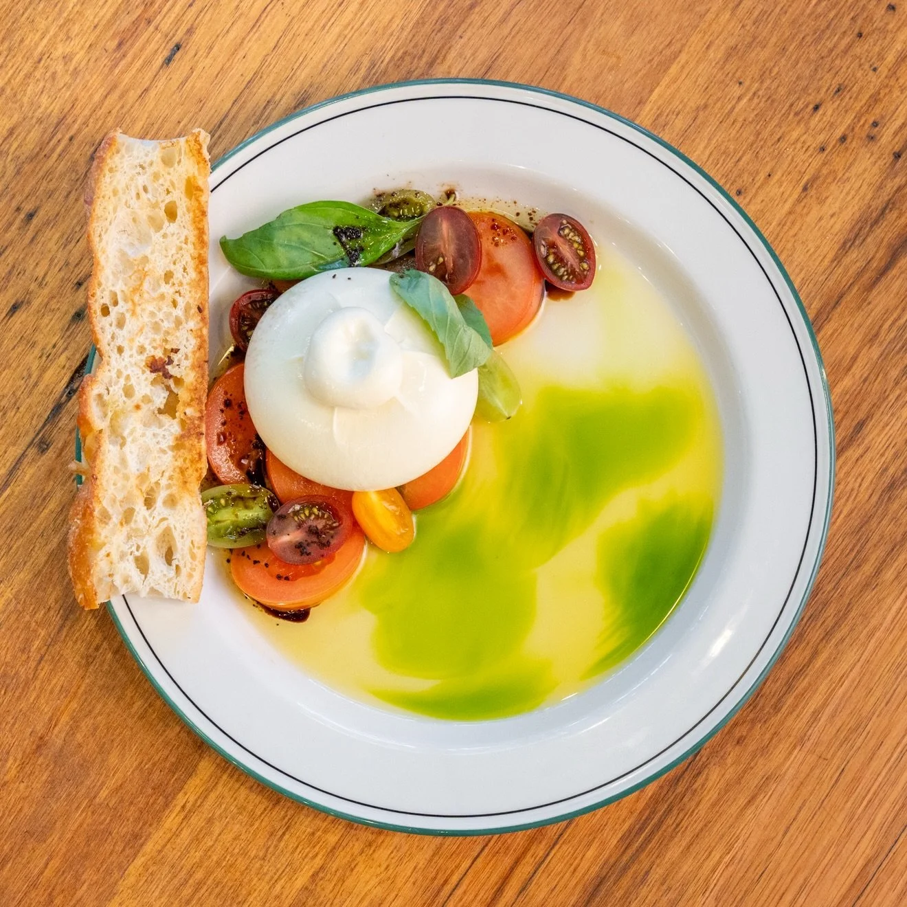 Next time you dine at Brown Cow, we recommend adding our burrata to your order. It&rsquo;s pretty as a picture and just as delicious to taste!

We serve this creamy cheese with heirloom tomato salad, green oil and an olive crumb, plus warm garlic foc