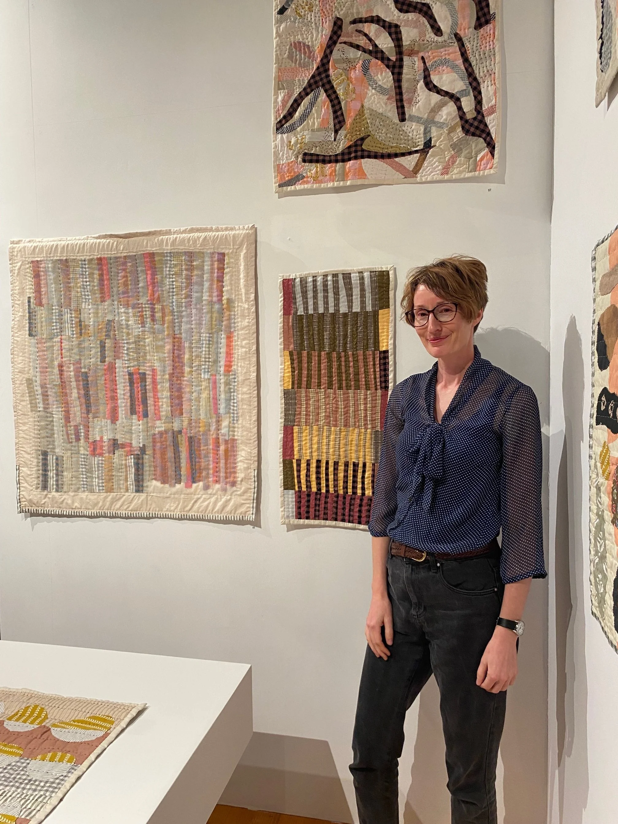 Mel Young in the exhibition space with her work.