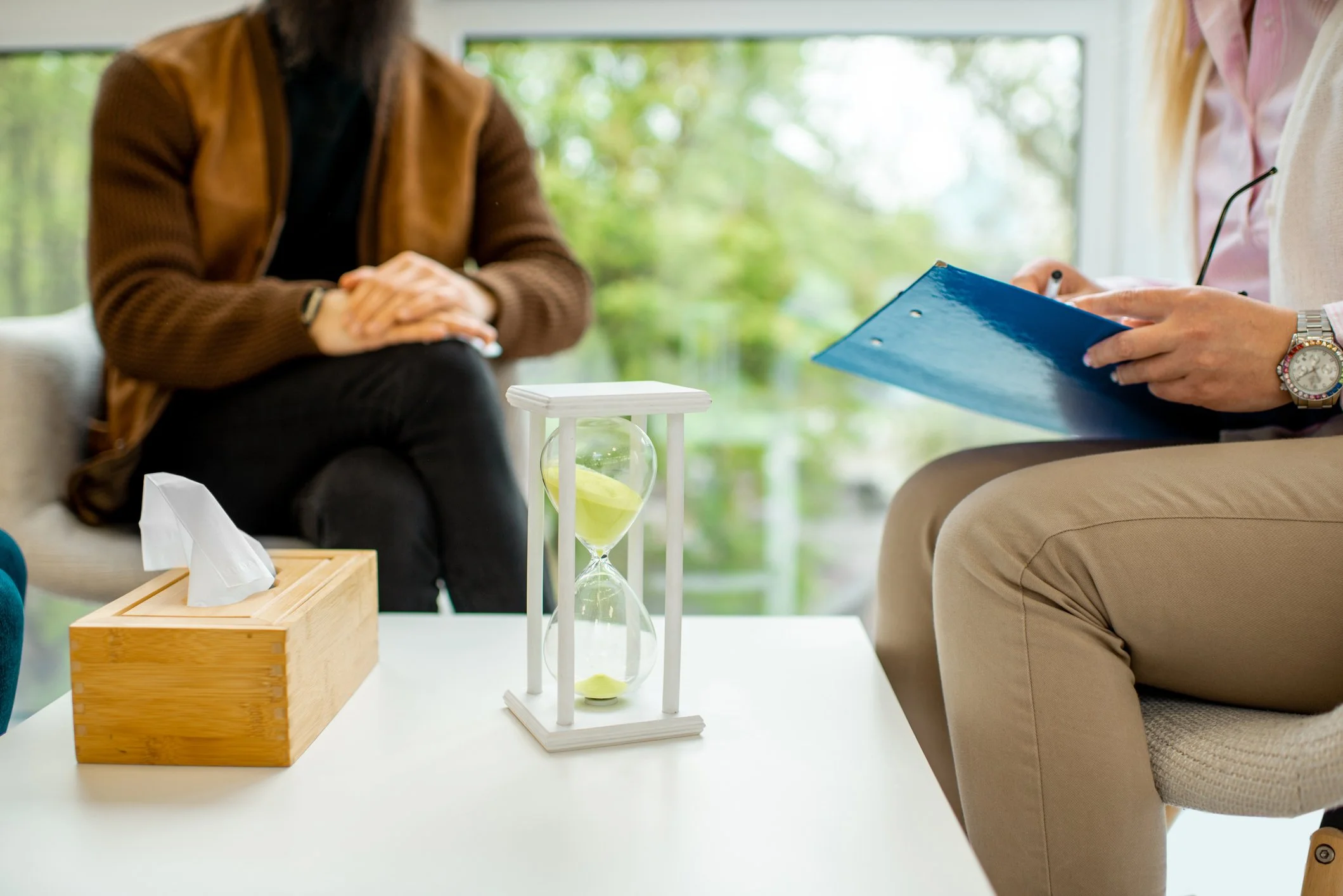 Image of a person's hand grounding onto a tree for sensory stabilization.
