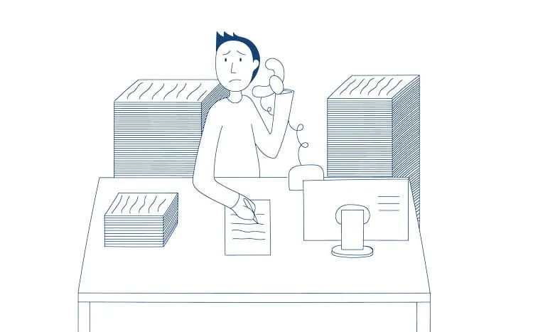 A man looking sad on the phone surrounded by piles of paper