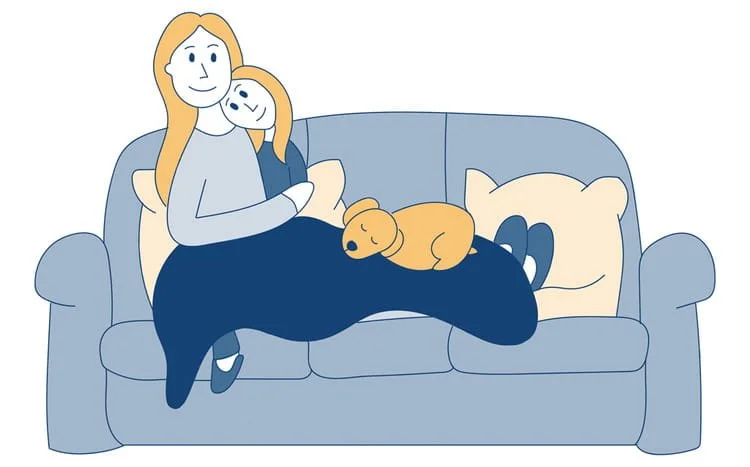 A woman and child curled up on a sofa with a dog