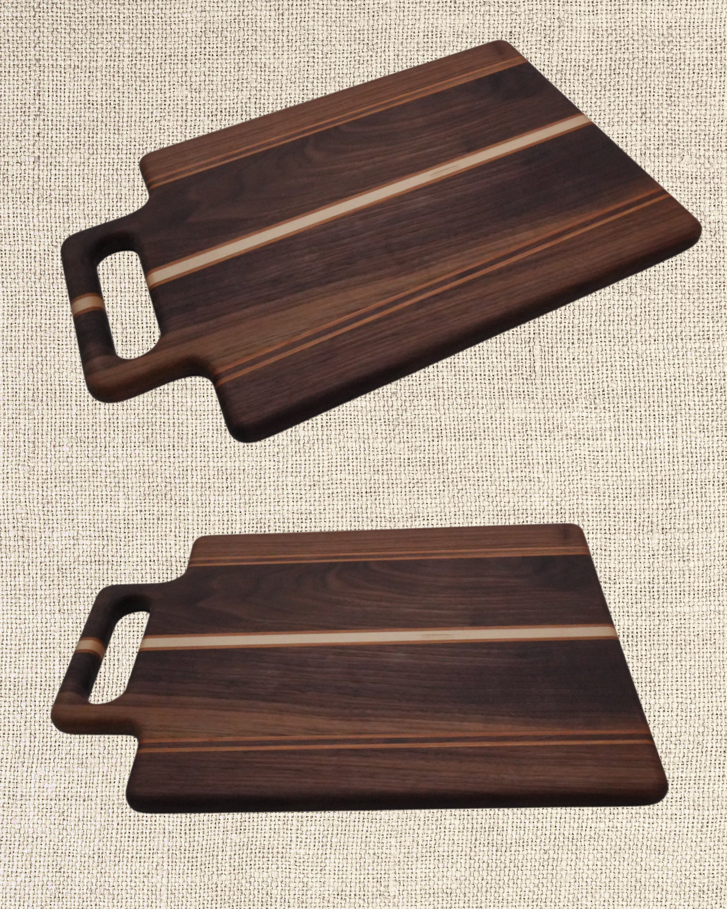 Two rectangular wooden cutting boards with handles, placed on a textured light-colored surface.