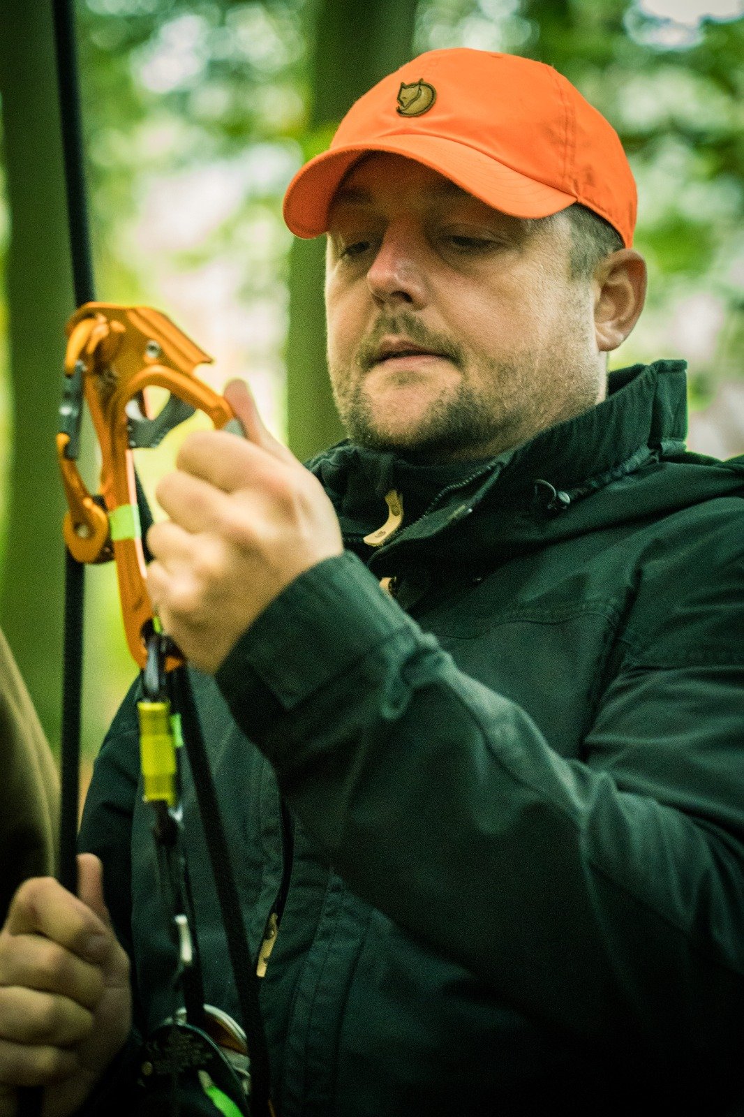 man with orange cap setting up camp gear.jpg