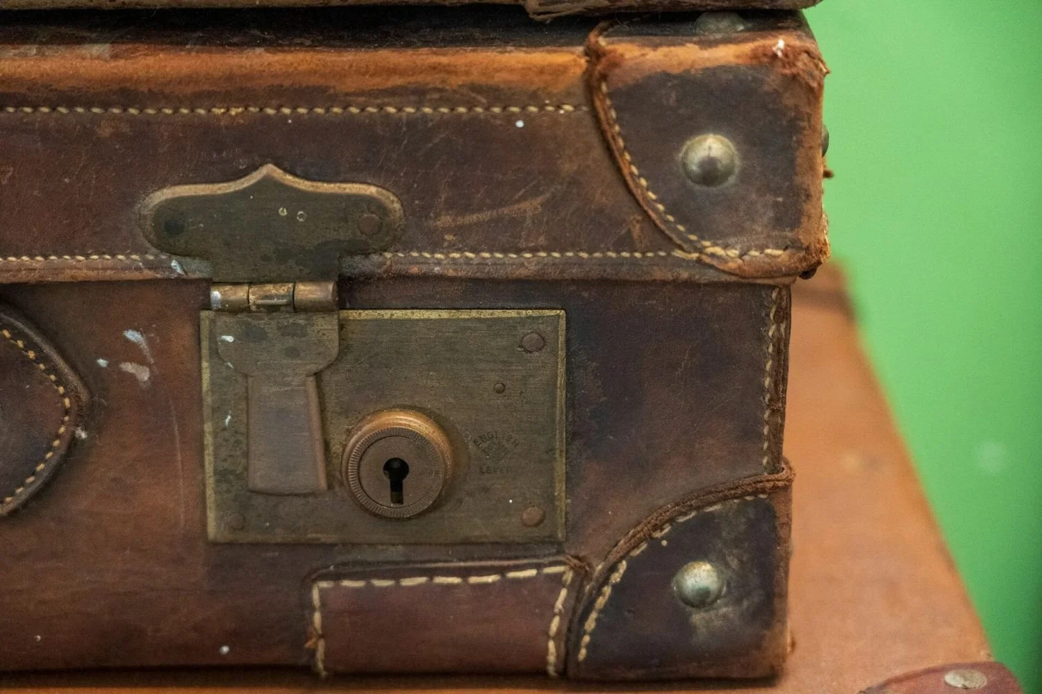 Weathered suitcase with a closed lock, representing grief and loss therapy with Rebecca Flores, LPC in San Antonio Texas