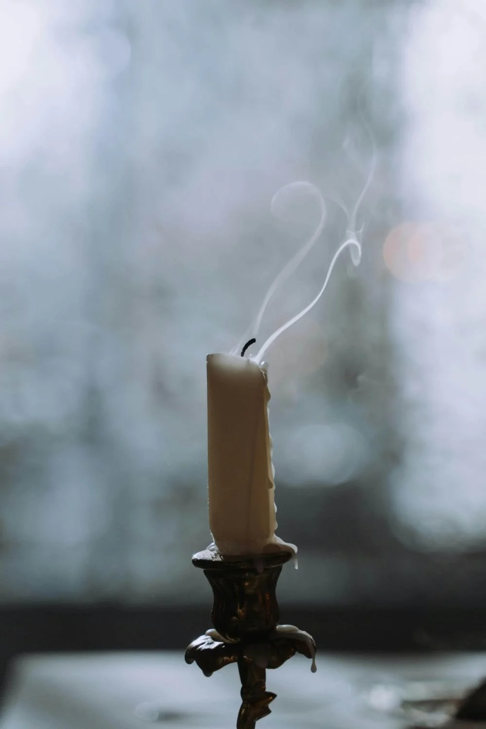 Single candle just blown out with smoke rising, grief and loss counseling San Antonio Texas