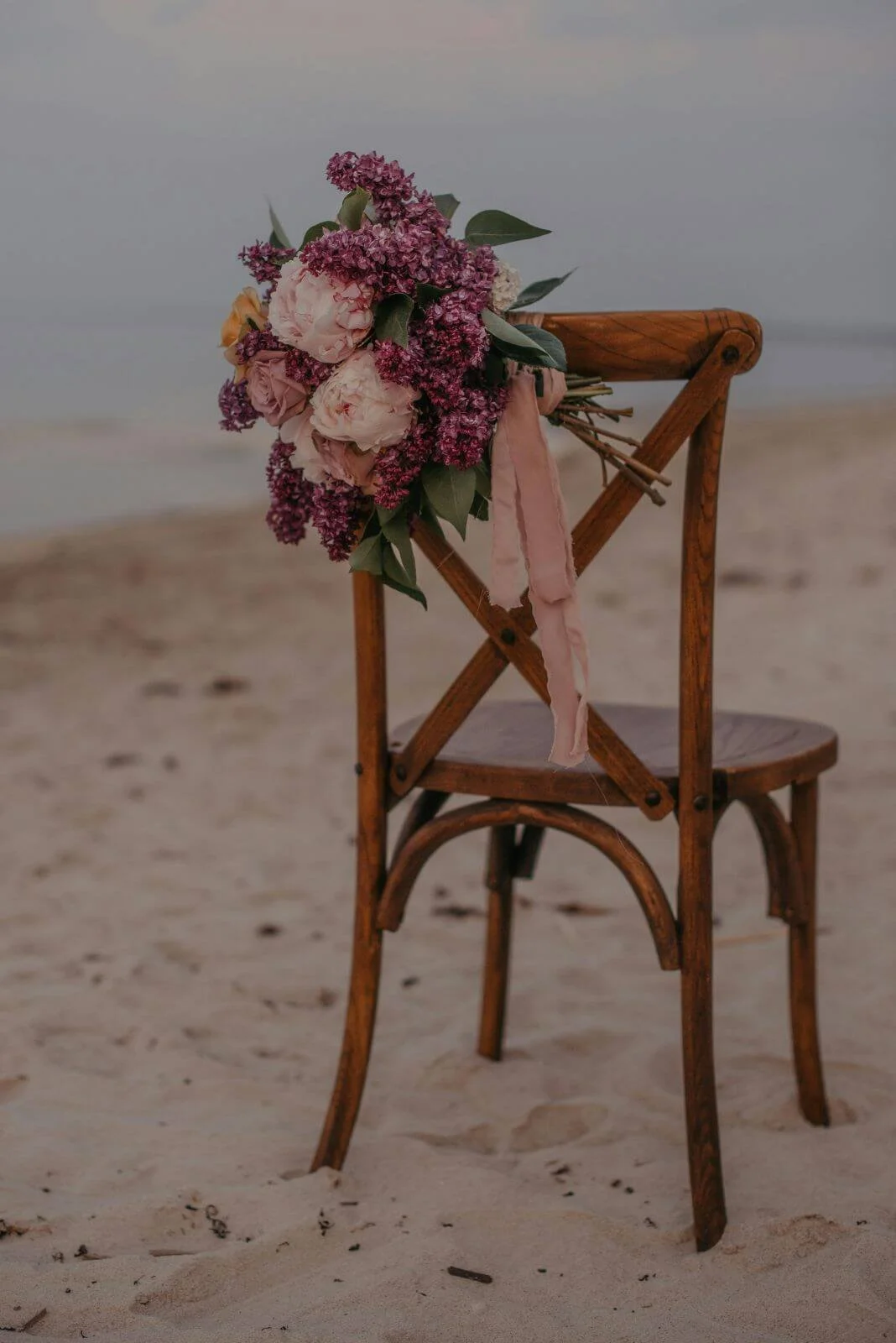 Empty chair with bouquet on a beach, attachment therapy in San Antonio with Rebecca Flores, LPC