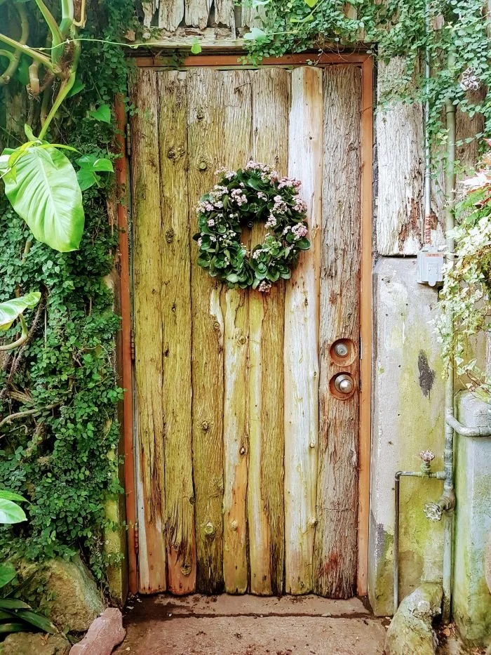 Rustic door with wreath, trauma therapy for women in Austin, Rebecca Flores, LPC.