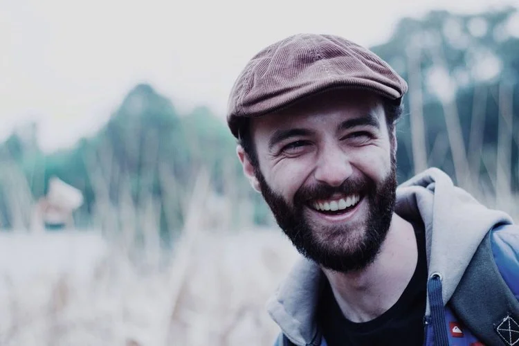 Smiling man in a stylish hat, therapy support for therapists San Antonio Texas