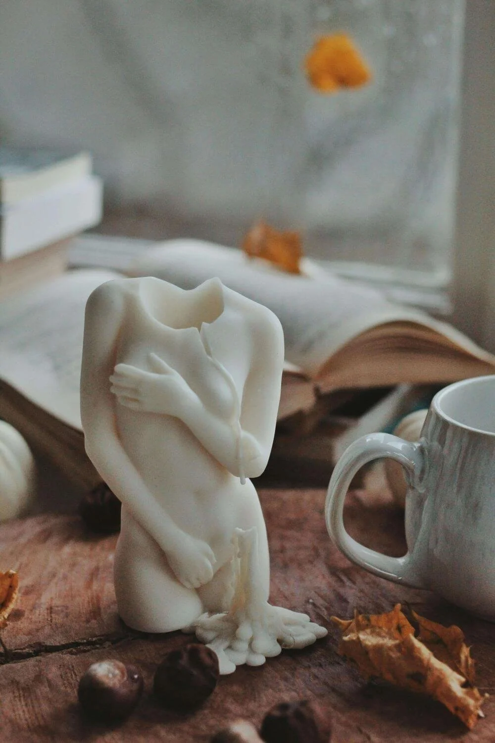Feminine figure near book and mug, attachment and trauma therapy in Austin.