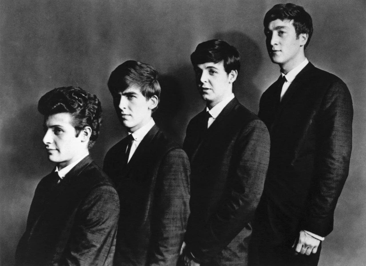   Pete, George, Paul, and John before their first show with suits in Manchester March 1962  