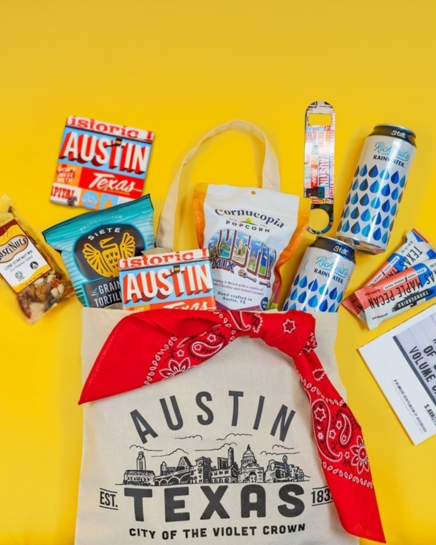 Austin, Texas themed amenity gift bag filled with local treats. Featuring Austinuts, Siete, Cornucopia, Richard's Rainwater, el Arroyo, Thunderbird, South Austin Gallery, and more!