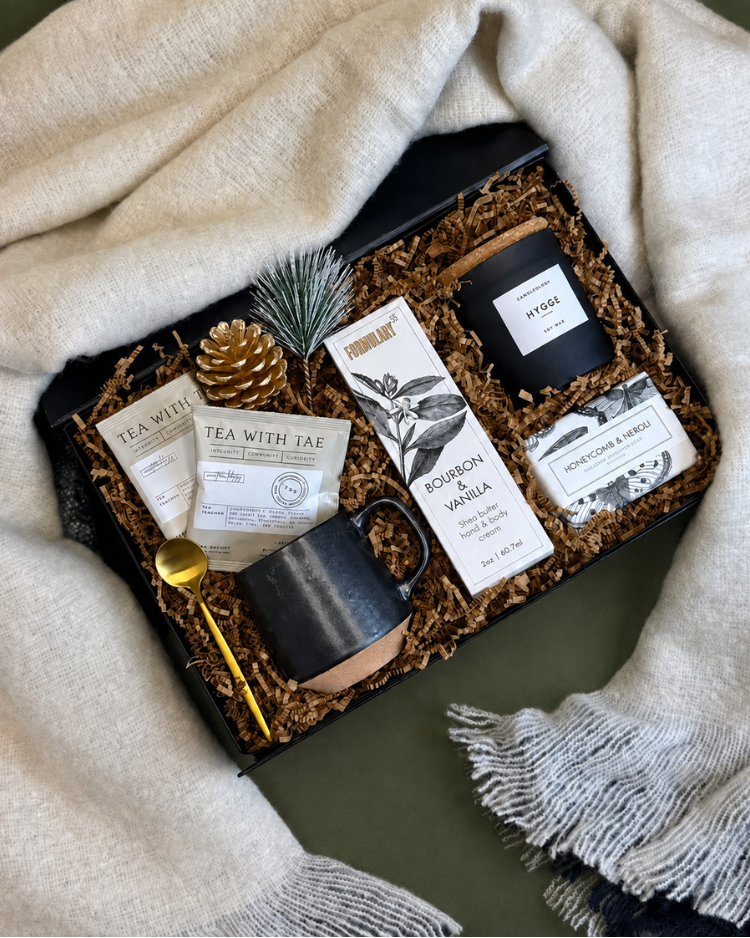Hygge Holiday gift, including Tea with Tae tea, Formulary 55 soap and lotions, a Hygge candle, soft blanket, and coffee mug and gold-toned spoon