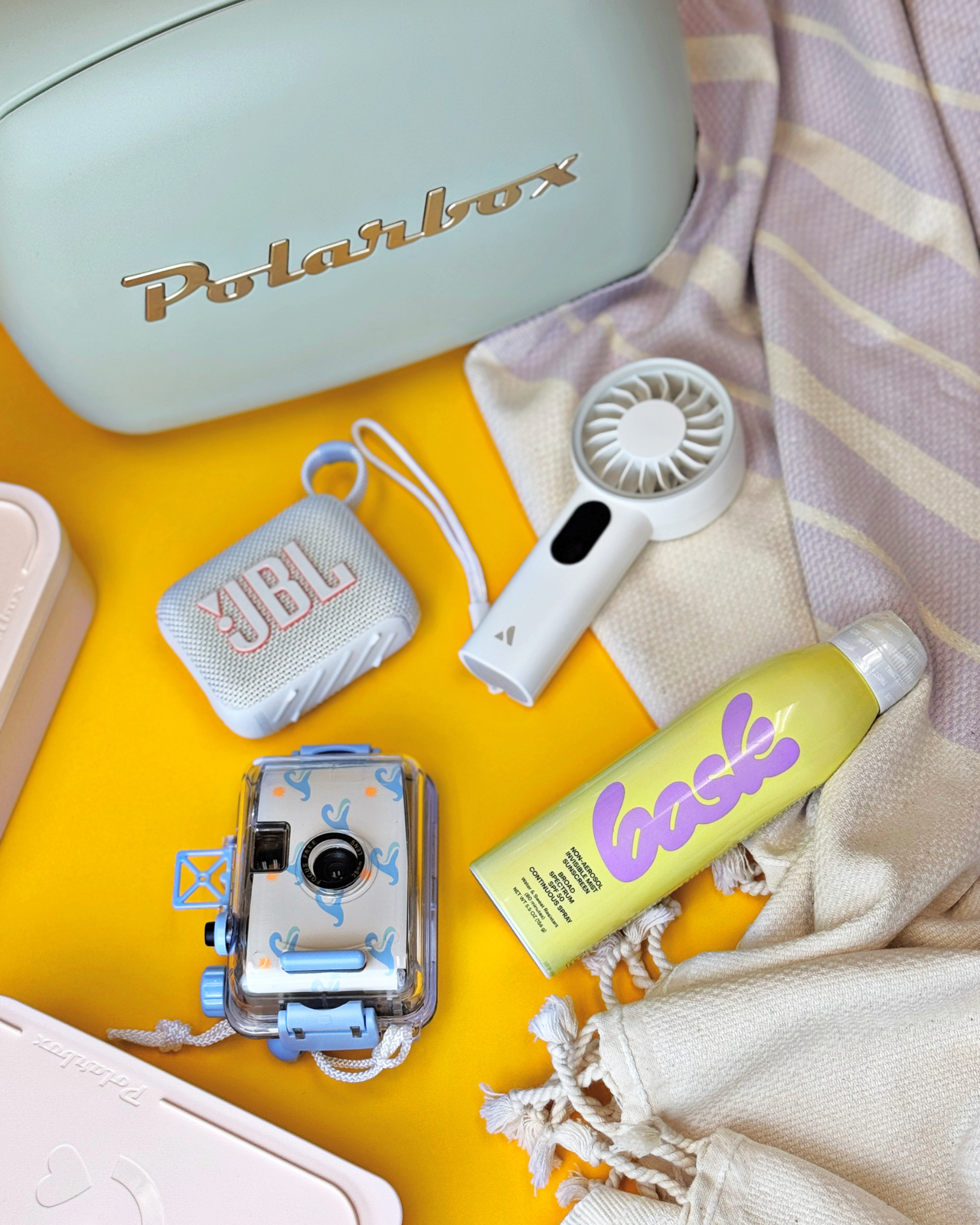 The Out of Office Gift, featuring a Polarbox cooler, Bask Sunscreen, Kaftan, Waterproof camera, and other sunny day essentials.