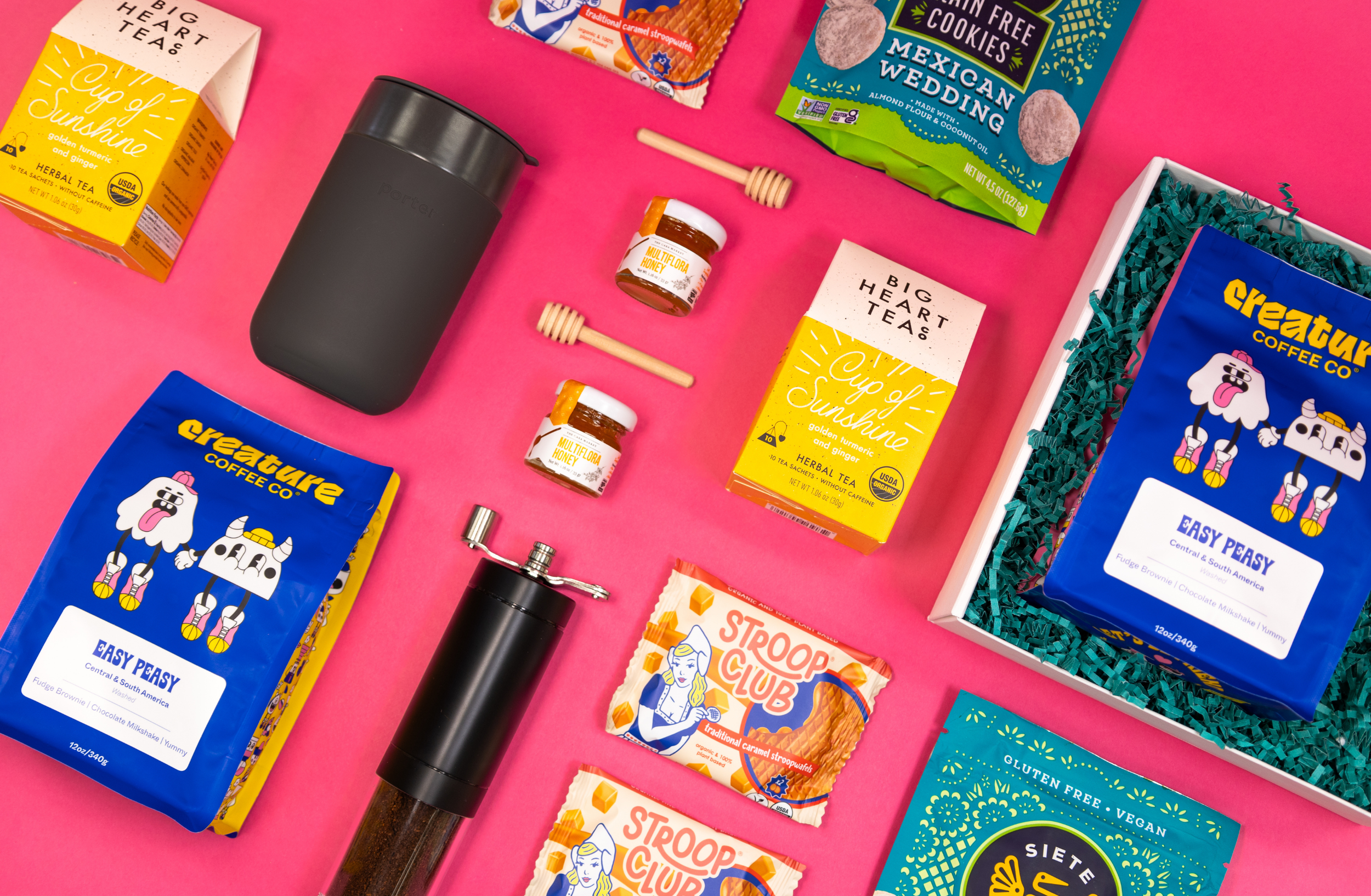 A flat lay of Creature Coffee, Stroop Club, Siete Cookies, and other coffee and tea items.