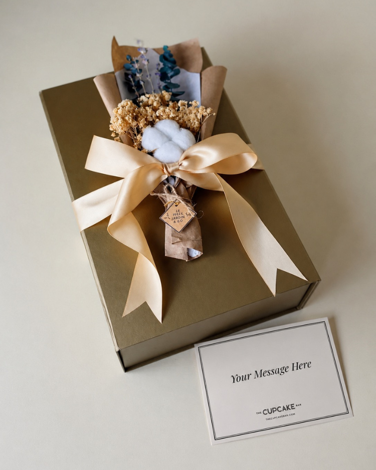 The Grand Maison Gift, featuring a cozy throw blanket, Le Jardin Reed Diffuser, Fragrance Oil, and Dried Bouquet. Gift wrapped with ribbon and handwritten notecard