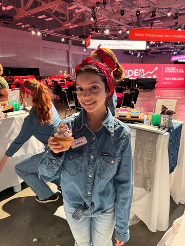 Cupcake bartender in all denim and a bandana serving conference desserts and funky Austin looks