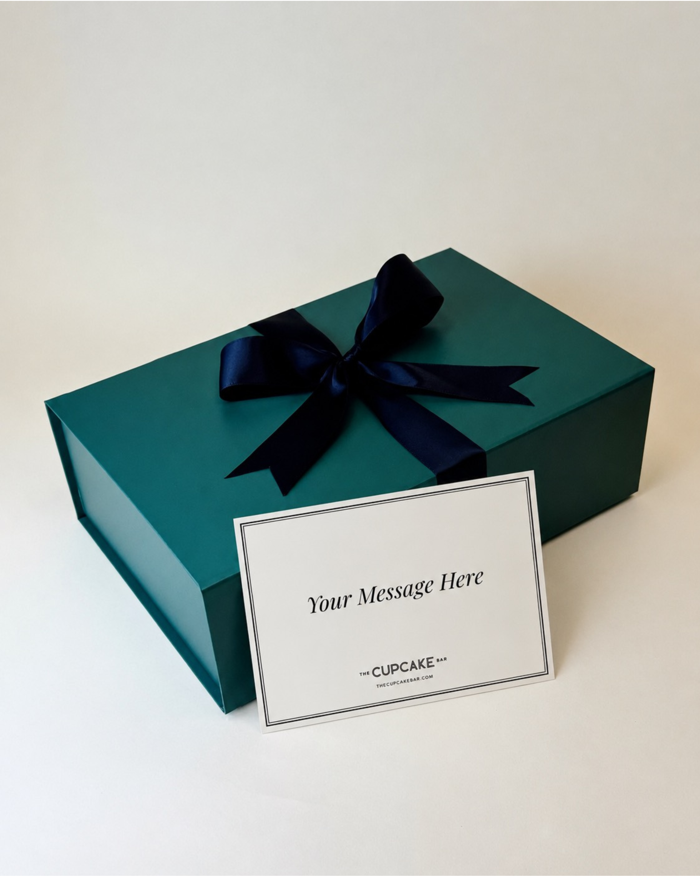 Premium magnetic-closure green gift box with black satin ribbon and handwritten notecard
