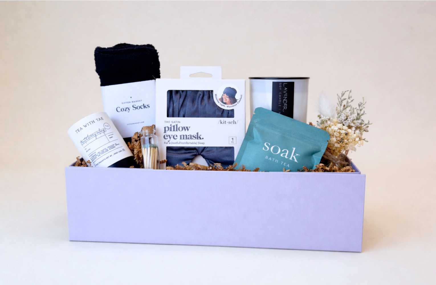 Our Relax and Unwind gift, featuring spa essentials, including cozy socks, tea, a candle, bath socks, and more