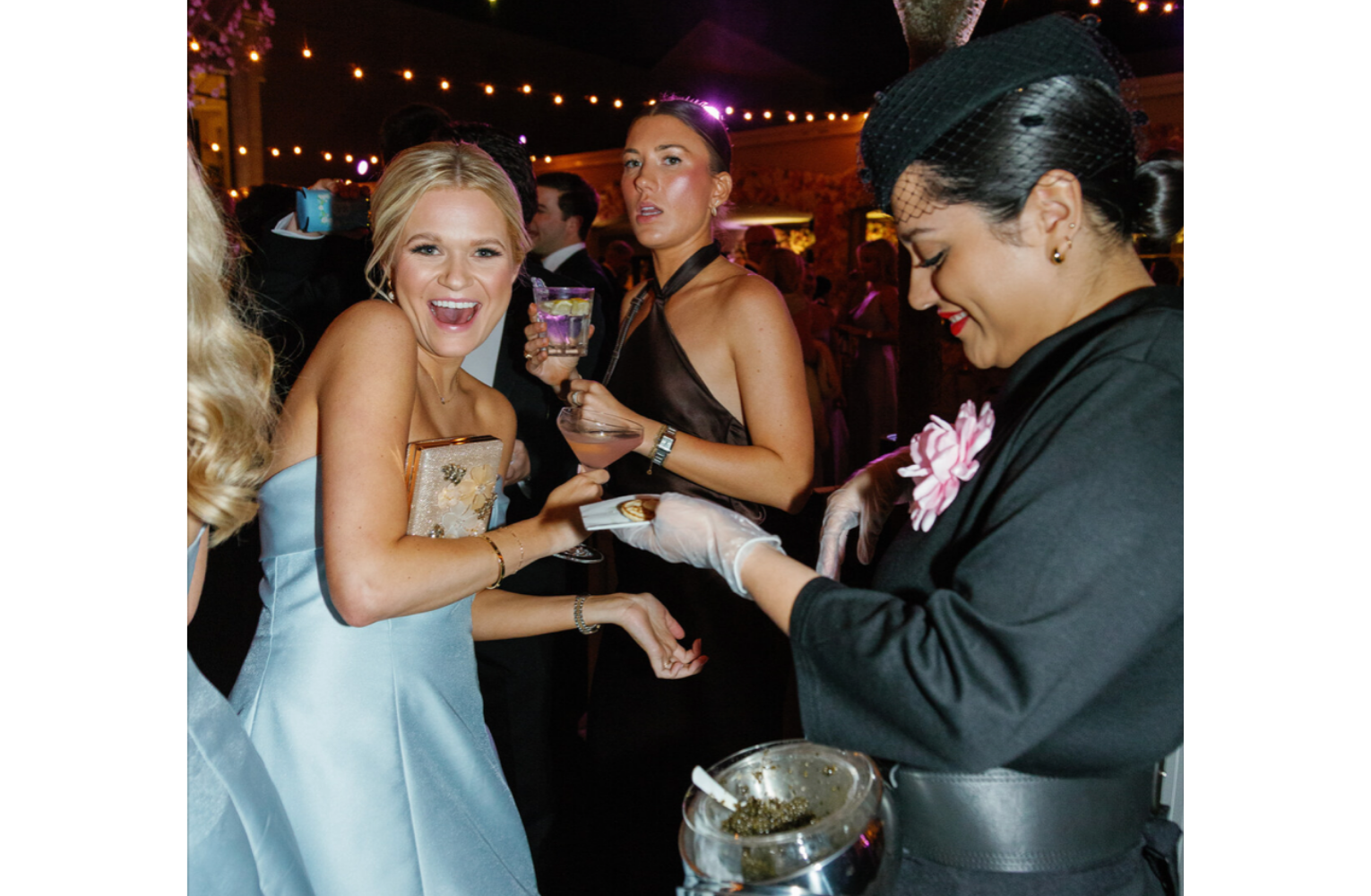 Attendant serves caviar to wedding guest at a luxury wedding