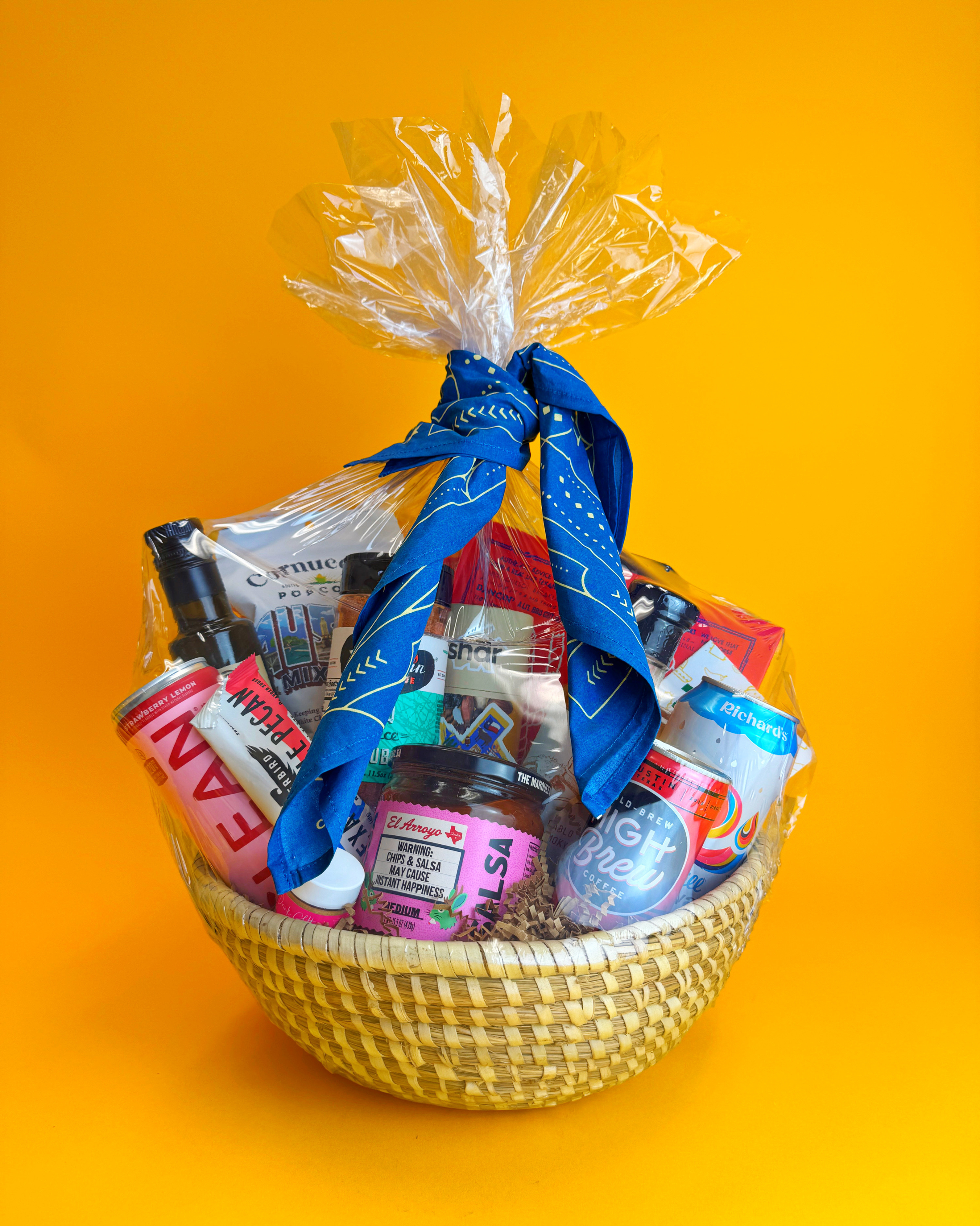 Expertly packaged gift basket containing local Austin favorite snacks, drinks, and keepsakes.