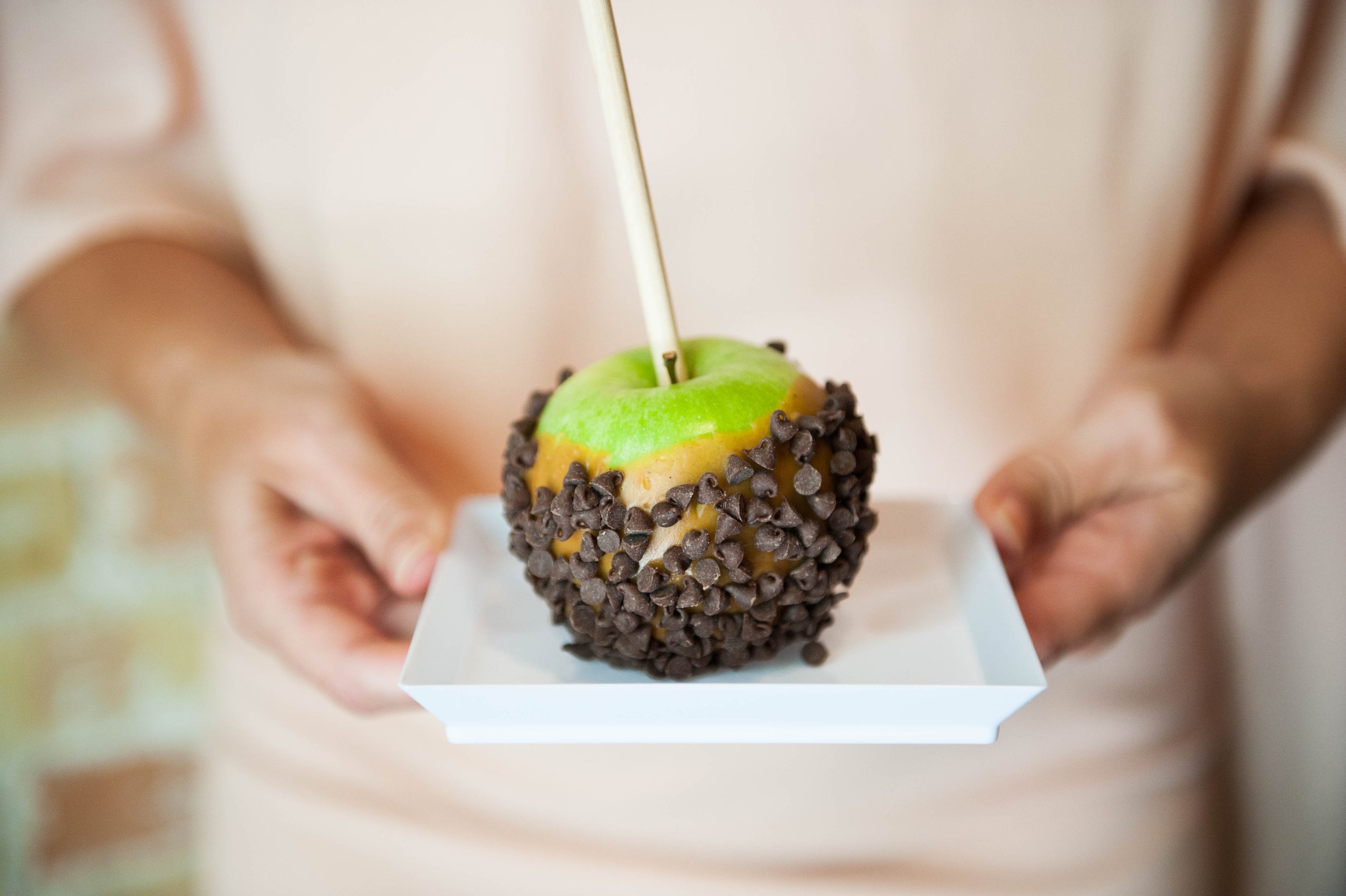 Close up of a custom Caramel Apple, made at The Cupcake Bar's caramel apple bar in Austin