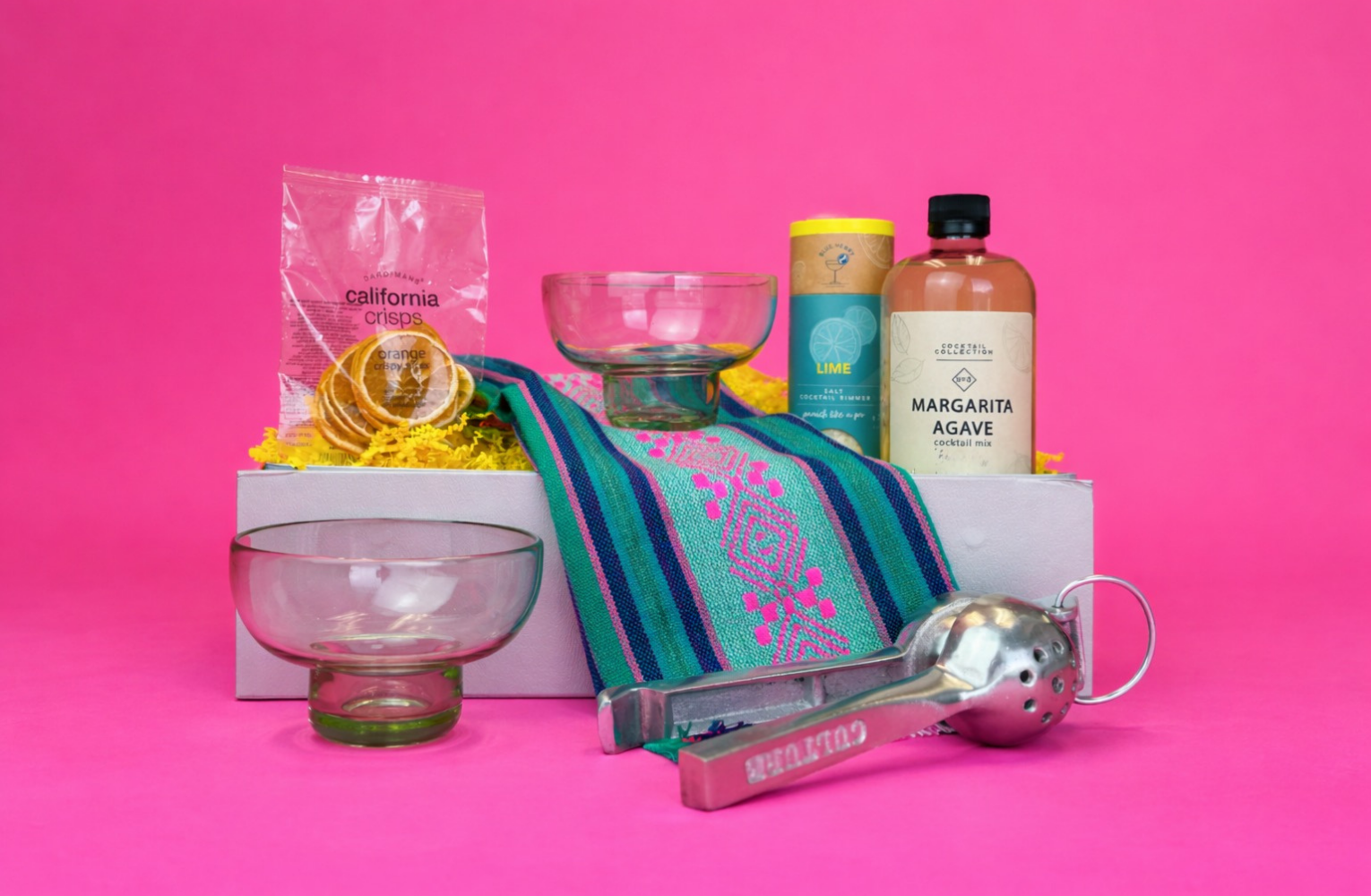 On the Rocks Margarita Gift with artisan made margarita glasses, a lime press, dried oranges, margarita mixer, lime rimming sugar, and a beautiful Mexican servetilla (woven cloth napkin)