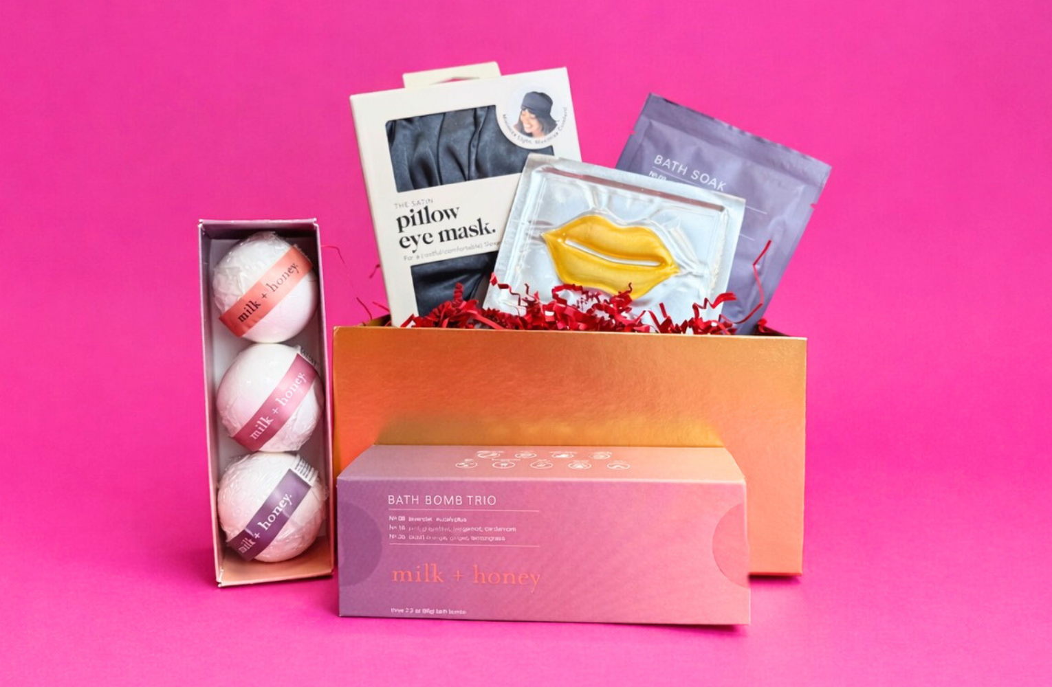 Spa-themed Valentine’s gift box on a pink background featuring bath bombs, eye mask, bath soak, and self-care items from local Austin businesses.