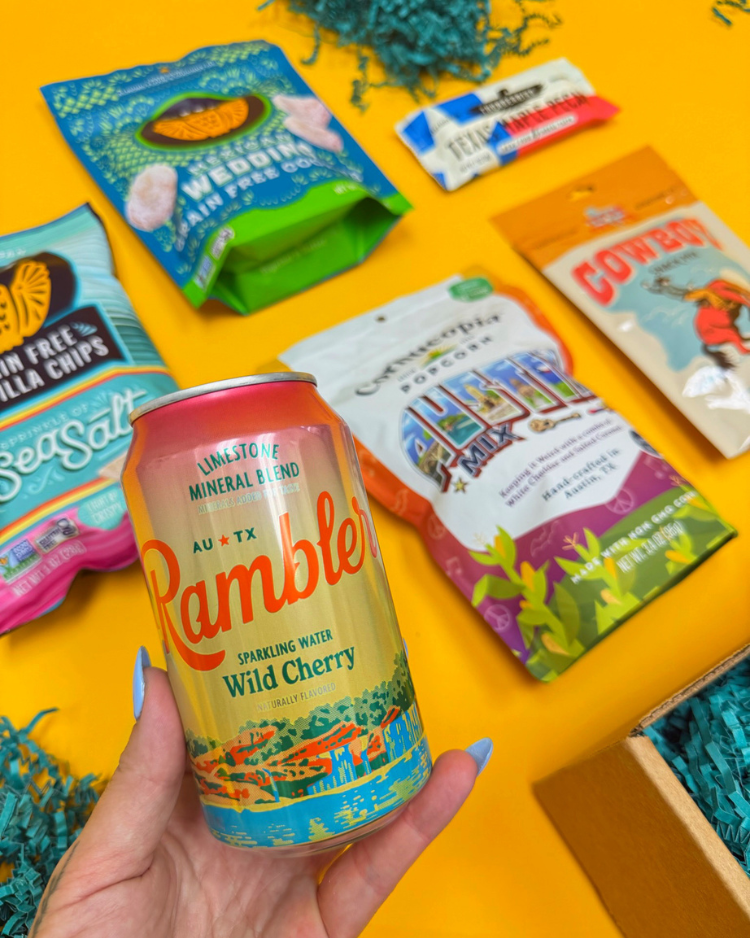Some items in Keep Austin Snacking, including Siete chips and Mexican wedding cookies, Rambler sparkling water, Cornucopia Austin Mix, Texas Treats Cowboy Snack Mix, and Thunderbird Texas Maple Pecan
