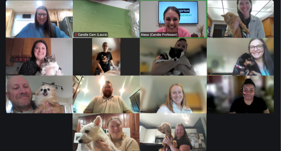 A screenshot of the virtual candle class participants from Enterprise, holding up their cats and dogs during a sweet moment in class!