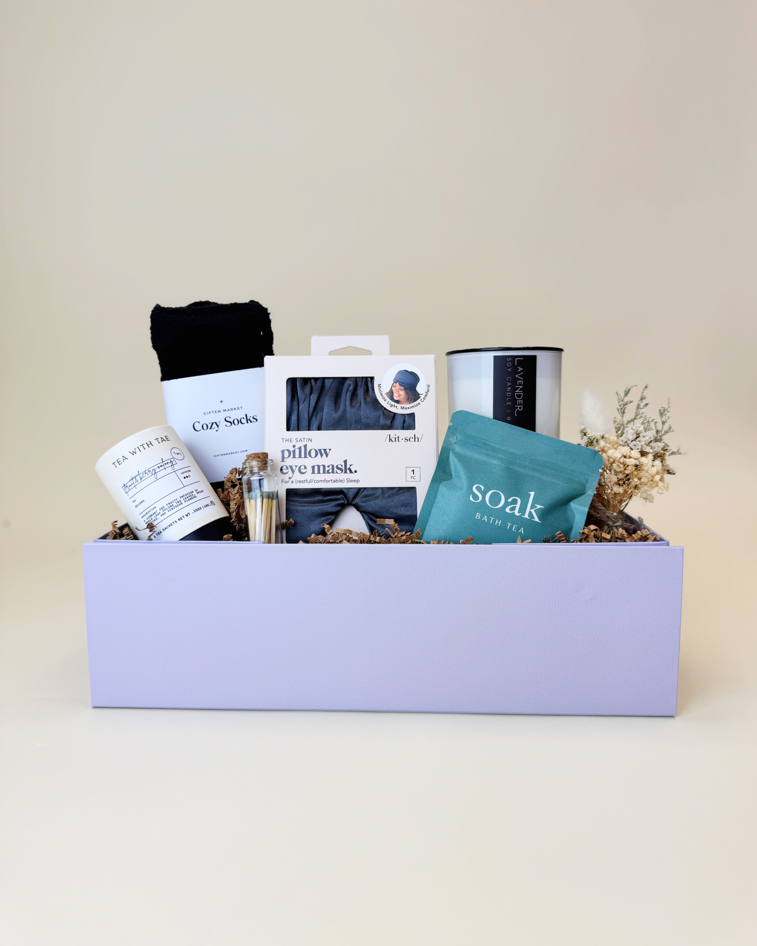 Curated spa gift box containing self-care items like a bath soak, tea, and an eye mask