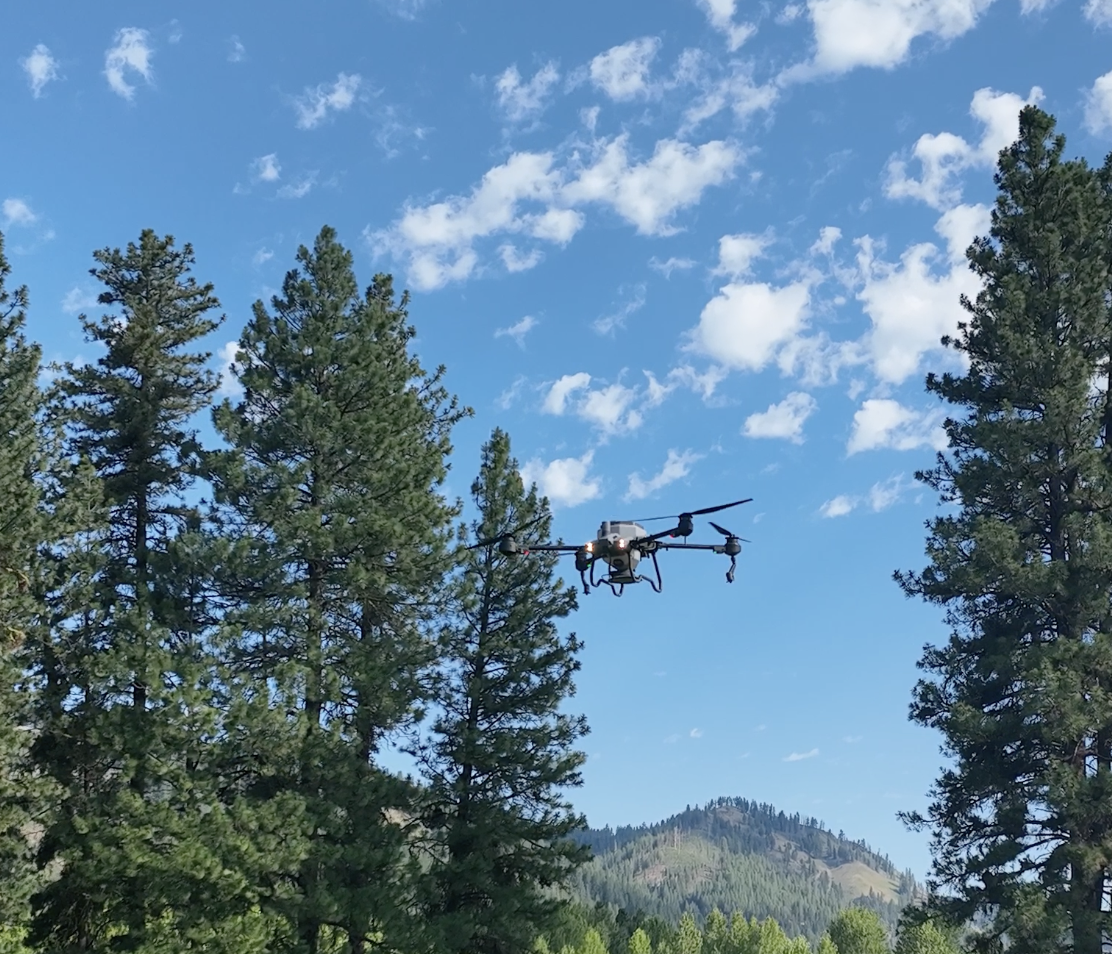 A drone spreading larvicide for mosquito abatement in mountain regions.