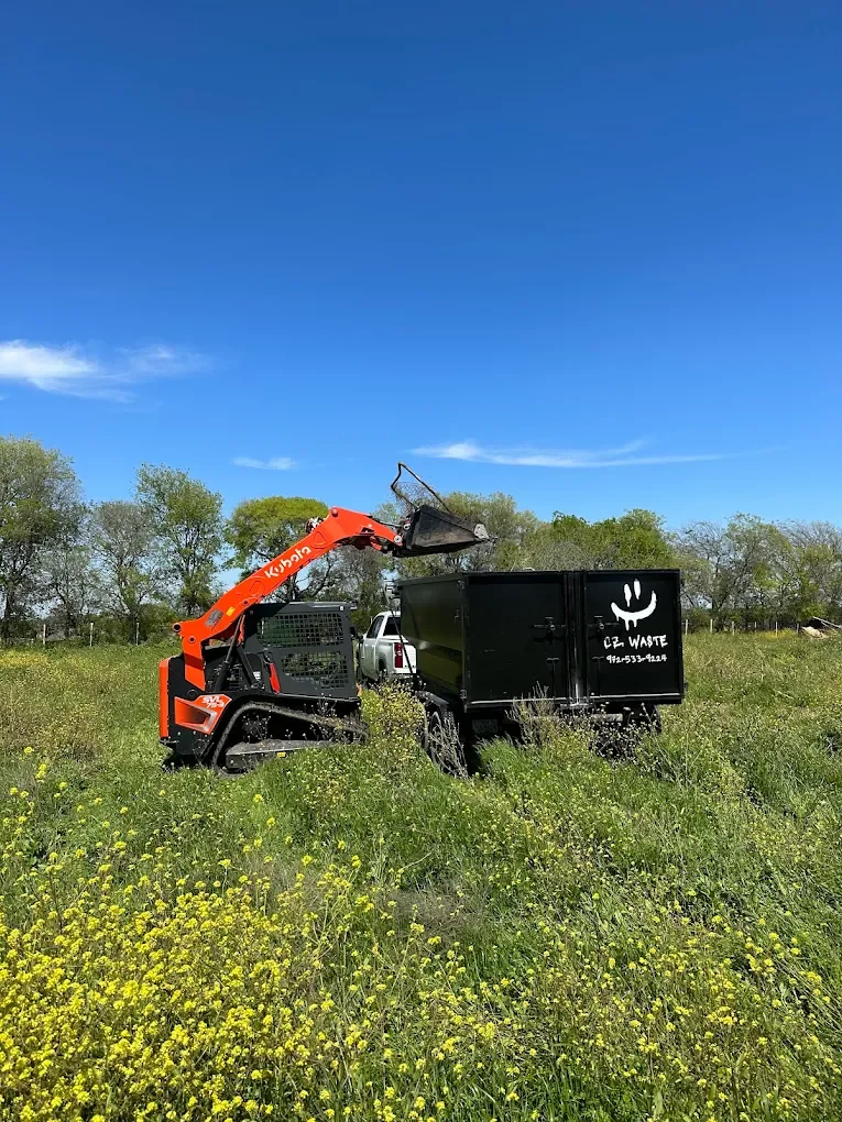 loading barn trash in a 17 yard dumpster Palmer Texas