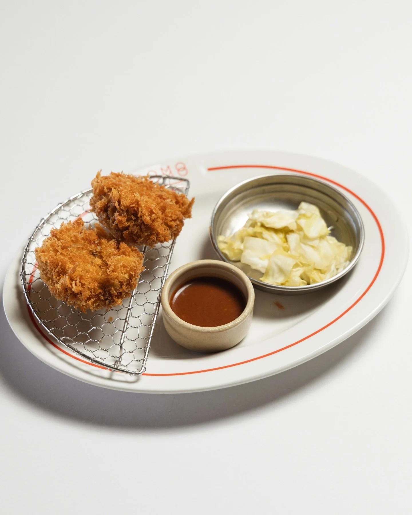 Menchi Katsu 
Golden-crisp, juicy, and finished with serrano pepper and pickled cabbage for a little kick.

#DomodomoHawaii #MenchiKatsu #JapaneseComfortFood #HonoluluEats #HawaiiEats