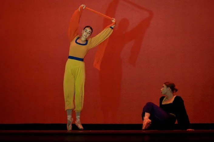 A dancer moves watched by the other