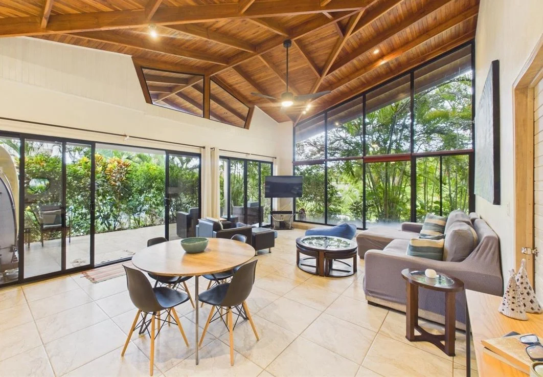 living room with wooden ceiling and large windows in a Nosara condo for sale