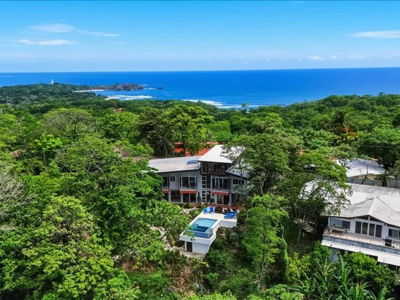 Aerial view of home surrounded by trees for sale in nosara