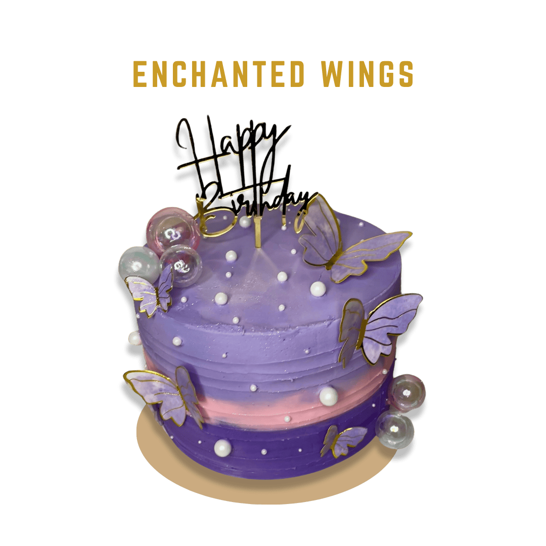 Enchanted Wings presents a Double Barrel cake design with lilac buttercream on the top, baby pink in the middle, and deep purple at the bottom. The cake is adorned with an assortment of white pearl-shaped sprinkles, purple and gold butterflies on the