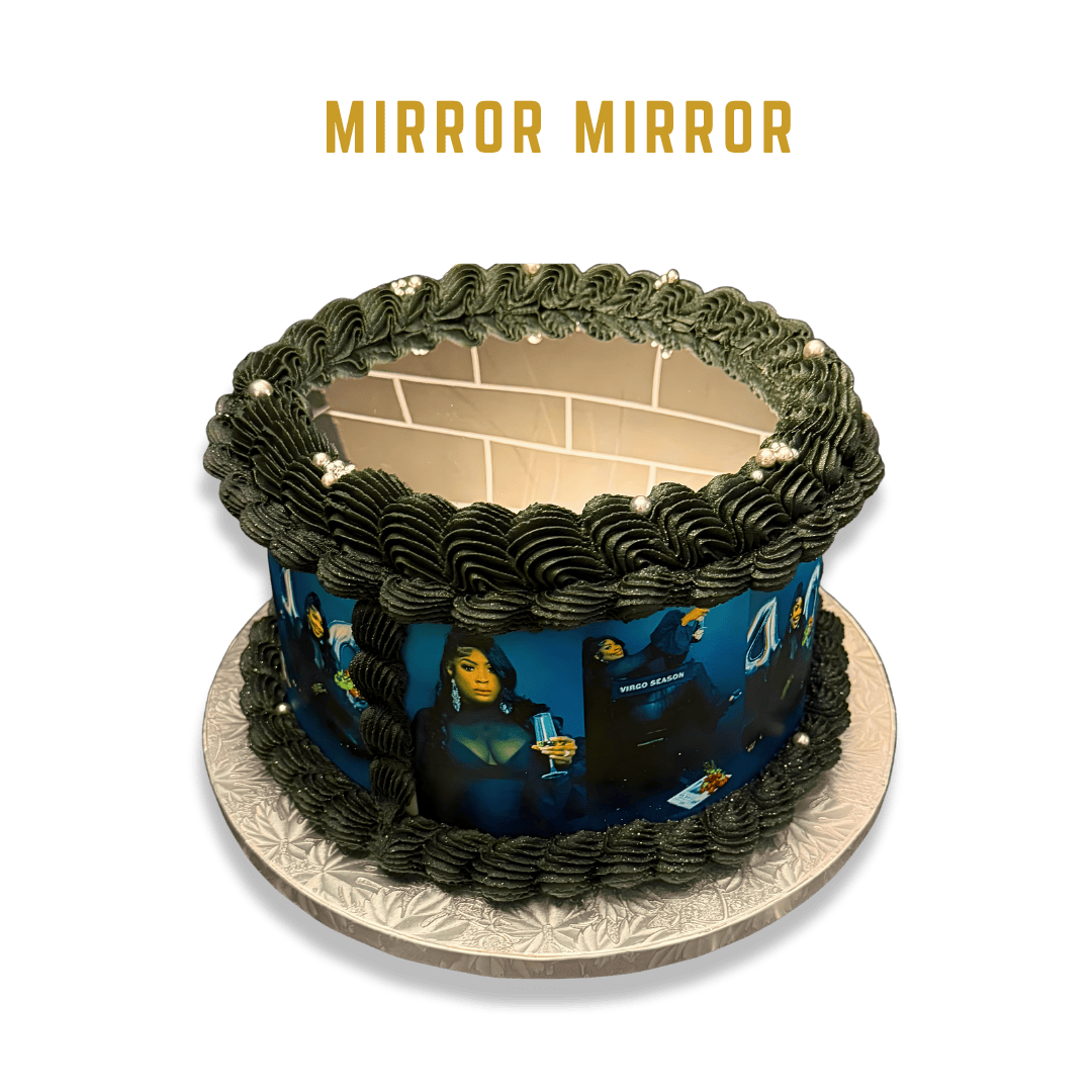 A birthday cake with black icing and a photo-themed edible print, featuring women and summer-themed images, with "MIRROR MIRROR" written above in gold lettering.